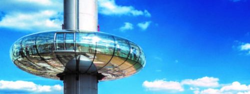 The Brighton i360 observation tower against a blue sky with clouds.
