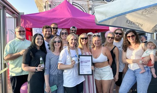 Group of joyful people celebrating an award at the Independent Lives Drop 360 event