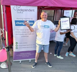 Mark proudly displaying his participation certificate at the Independent Lives Drop 360 event.