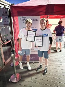 Two joyful participants, Mark and Tom, holding their certificates at the Independent Lives Drop 360 event.