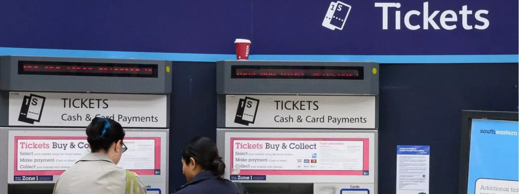 Two ticket vending machines with options for cash and card payments at a station.