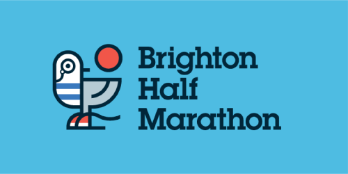 The image features the logo for the Brighton Half Marathon. It showcases a stylised illustration of a seagull, designed in a modern and simplistic manner with stripes and a red dot, next to the text "Brighton Half Marathon" in bold, dark lettering. The background is a solid, bright blue, creating a striking contrast with the white and red elements of the seagull and the dark text. The overall design conveys a sense of the coastal location and the dynamic nature of the event.