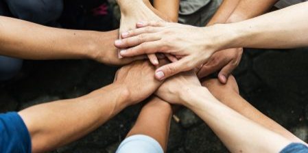 Group of people United Hands to built teamwork together with Spirit - teamwork concepts.