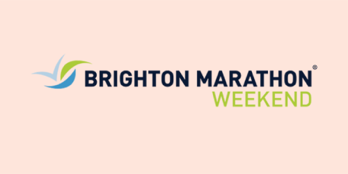 The image displays the logo for the Brighton Marathon Weekend. The logo consists of a stylised, swift checkmark with blue and green gradients, symbolising movement and vitality. Next to it, the words "BRIGHTON MARATHON" are written in bold, dark blue capital letters, with "WEEKEND" underneath in a vibrant green hue, both set against a pale background. The logo communicates energy and the spirit of a communal sporting event.