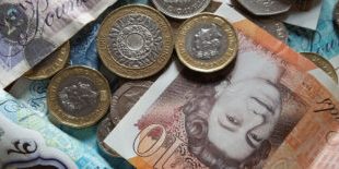 Close-up of various British currency notes and coins